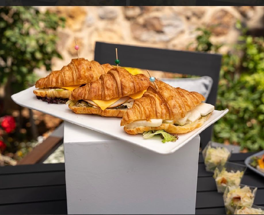 Large croissant sandwiches on a platter