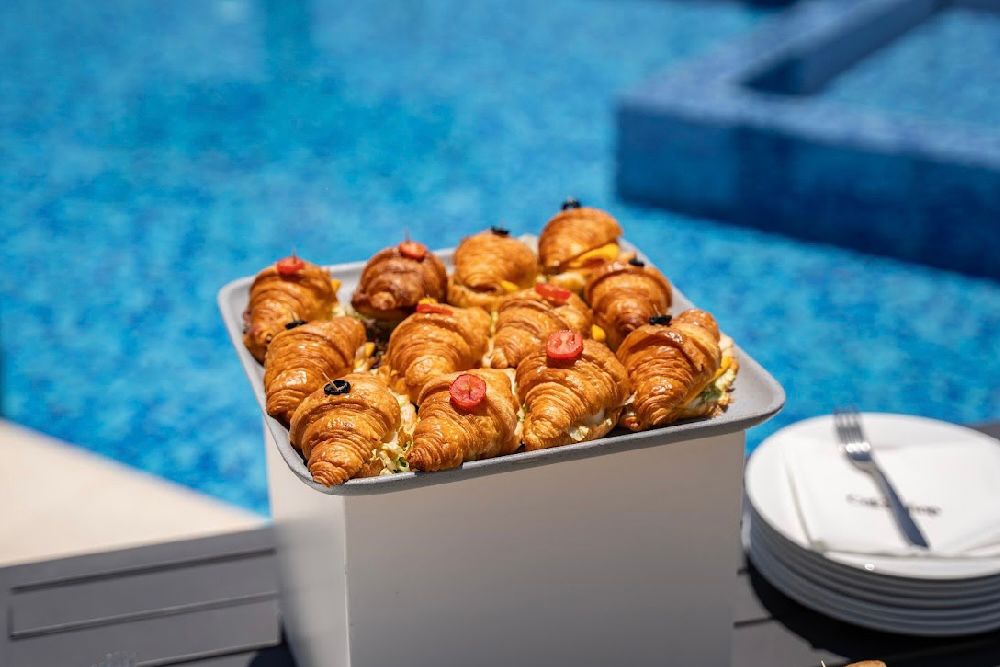 Tray of assorted mini croissant sandwiches